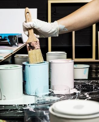 artists-using-paint-from-cans-with-brush