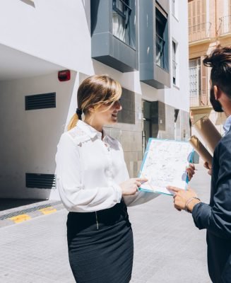 smiley-real-estate-agent-talking-architect